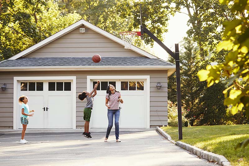 A family playing basketball on driveway