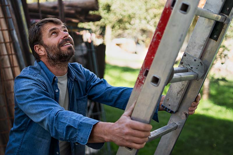 Man placing a ladder