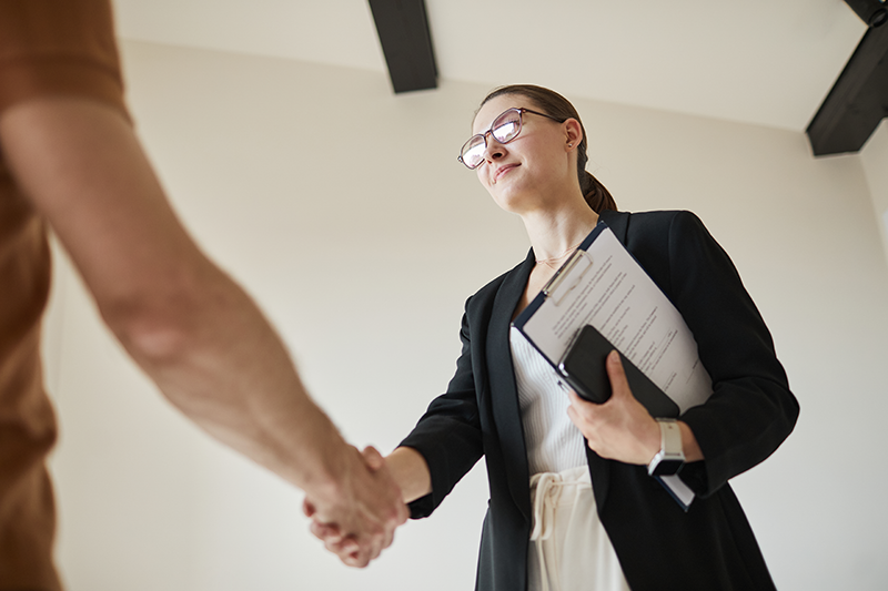 Realtor shaking hands with a man
